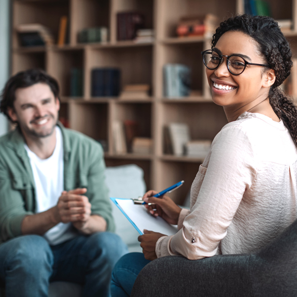 Therapist and client in therapy session discussing practice growth strategies.